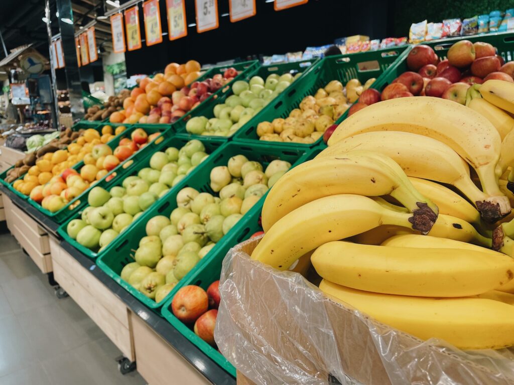 Supermarket vegetable department. Selling bananas, apples, oranges, pears. Fruits market stalls